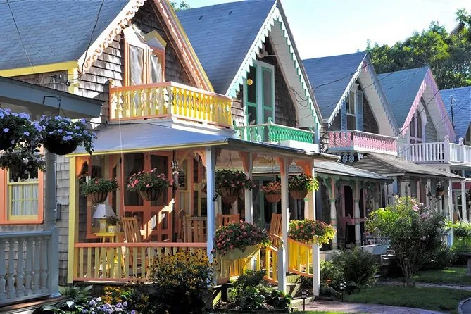 Gingerbread cottages with yellow, pink and green porches and hanging flower baskets
